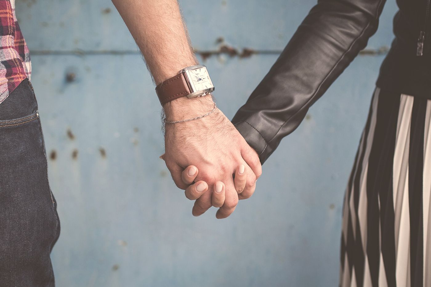 Two people holding hands